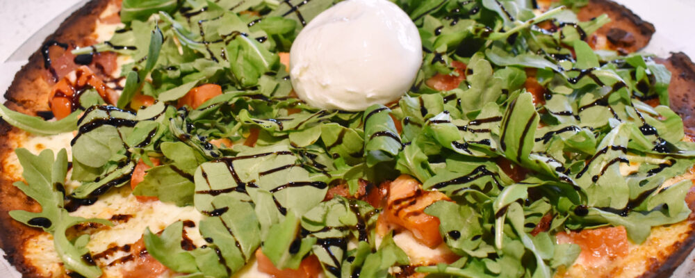 Christos arugula and prosciutto pizza