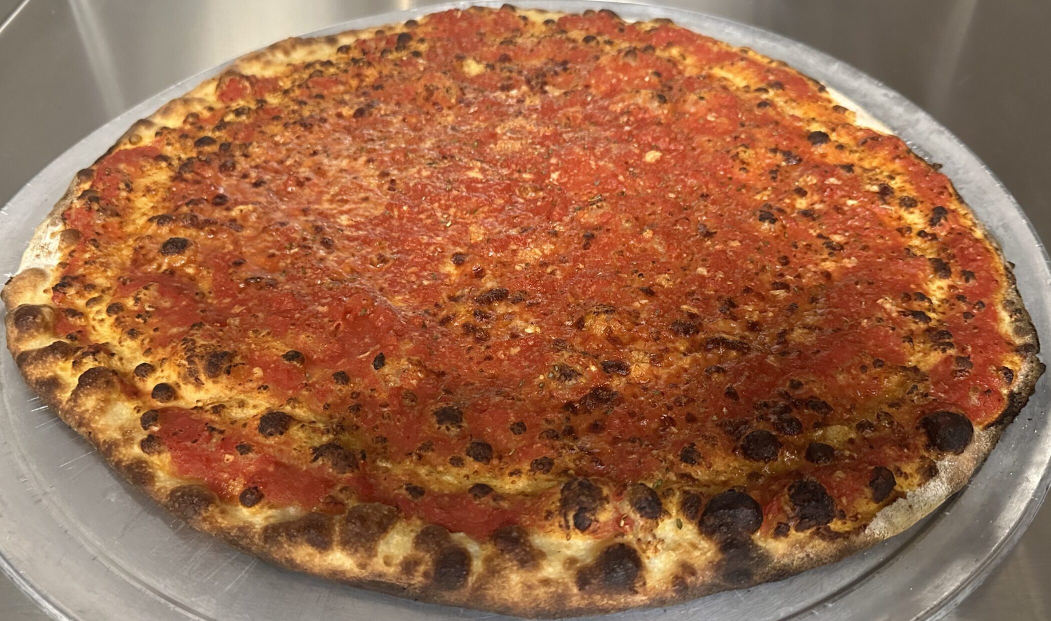 Christos Original Wooster pizza with rich red tomato sauce and Pecorino Romano