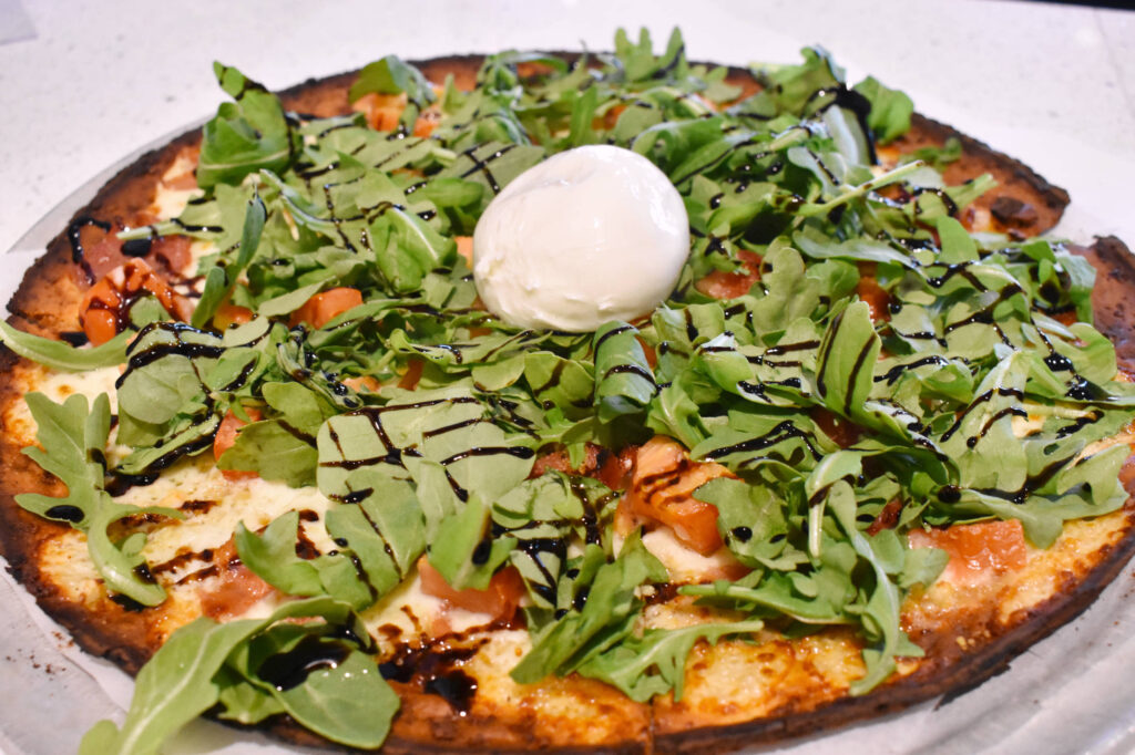 arugula prosciutto pizza at Christos Restaurant and Bar